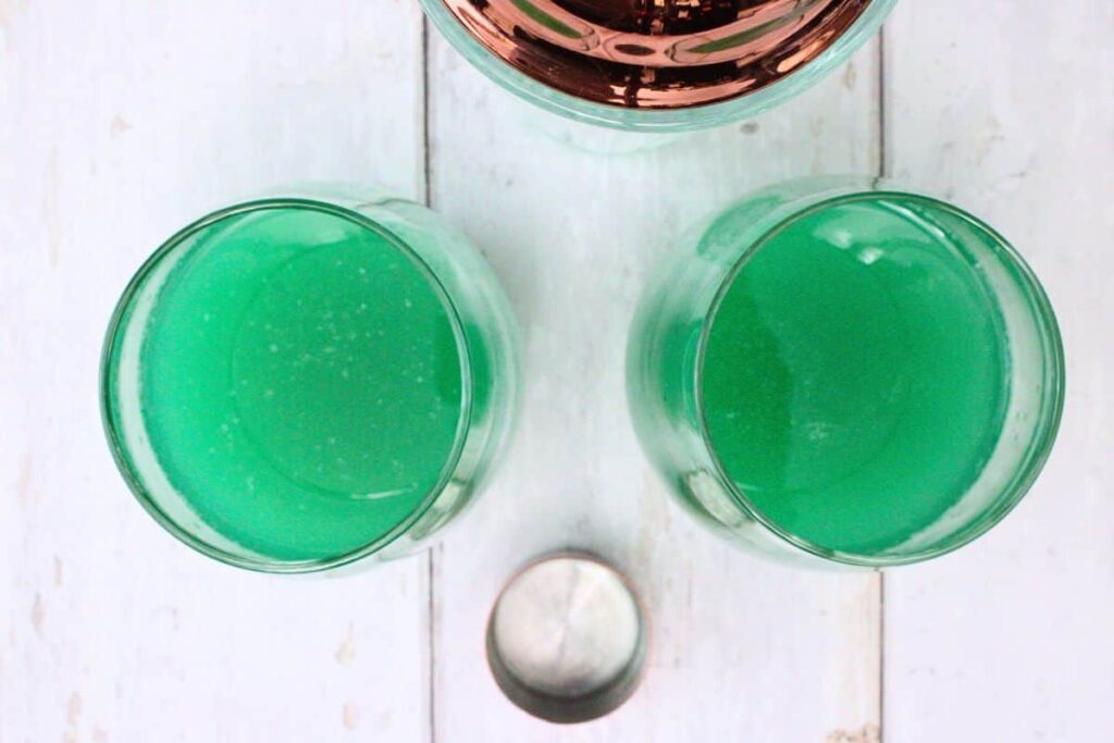 shake and strain luck of the irish cocktail into glasses