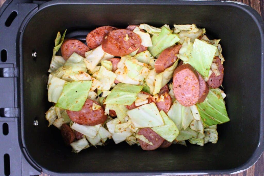 add cabbage and sausage mixture to air fryer basket