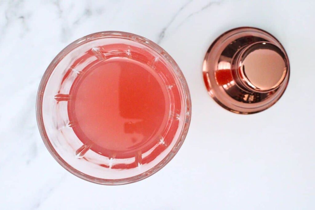 add pink whitney cosmo ingredients to cocktail shaker