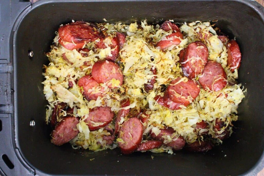 add seasoned sauerkraut to kielbasa in air fryer basket