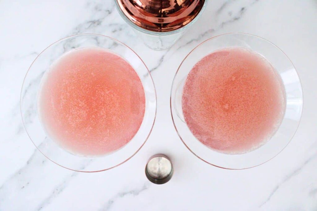 shake and strain chilled pink whitney cosmo into glass
