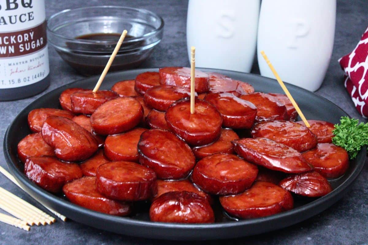 black plate filled with air fryer kielbasa bites with a bbq glaze