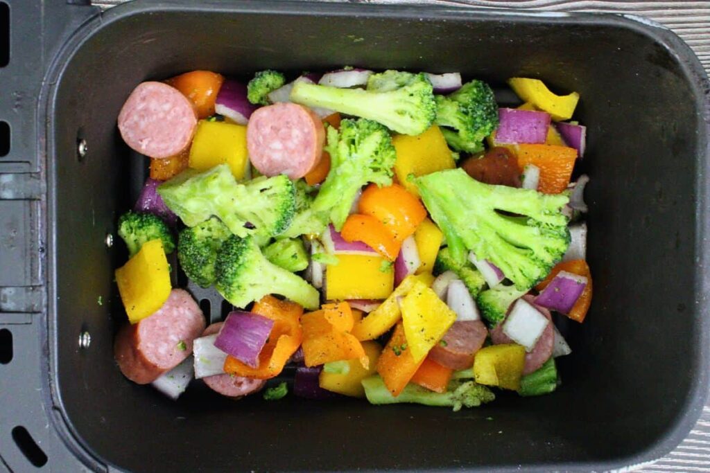 add seasoned vegetables and kielbasa to air fryer basket