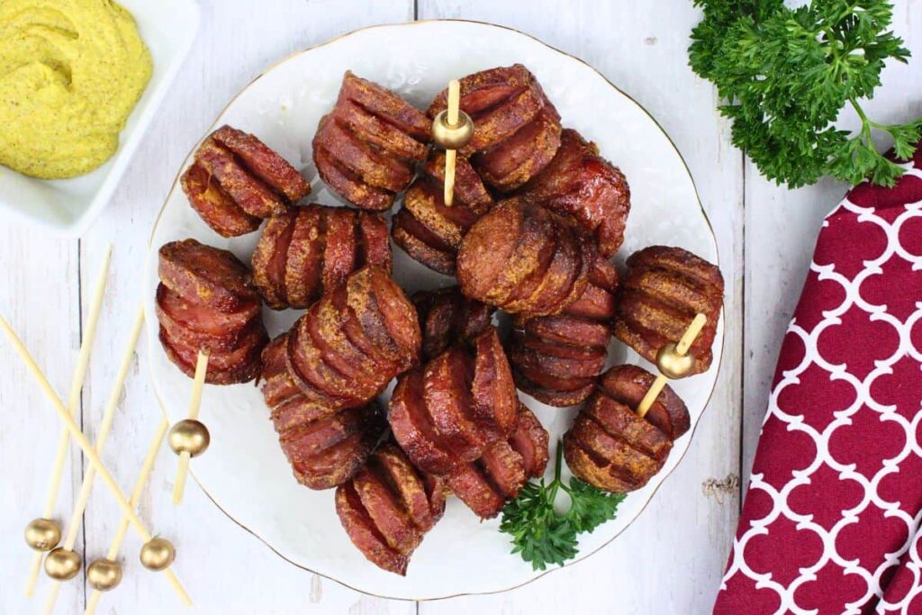overhead view of air fryer hasselback kielbasa bites with candied brown sugar glaze