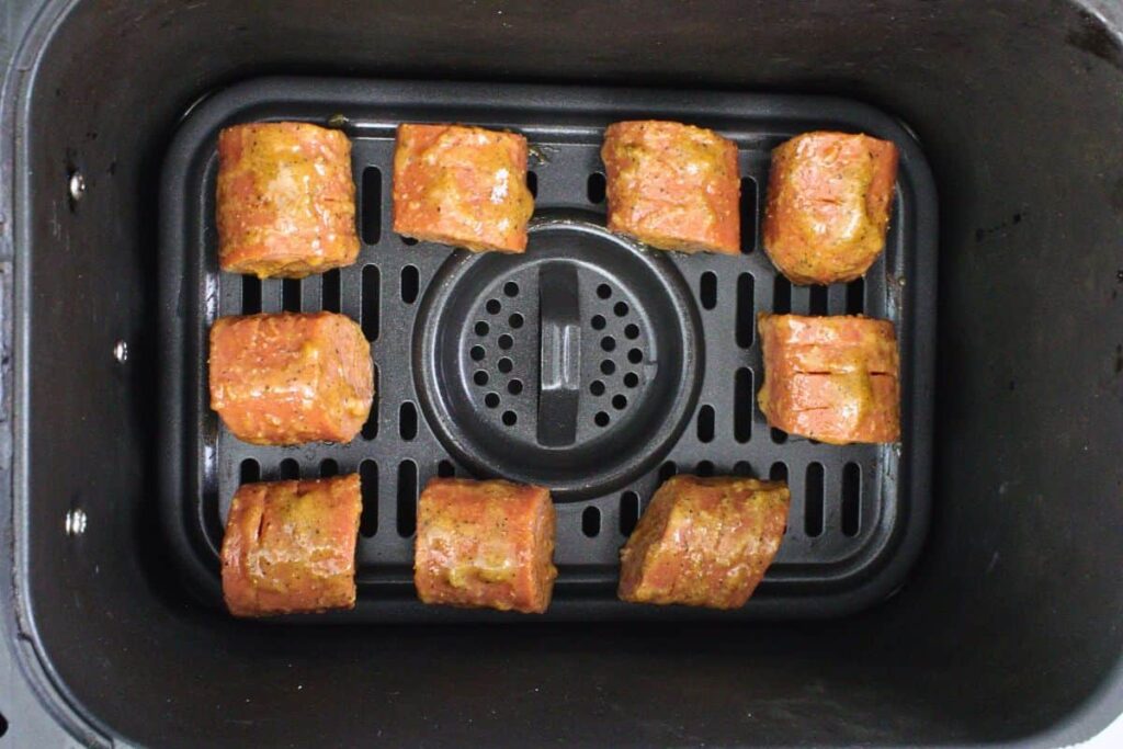 place coated hasselback kielbasa in air fryer basket