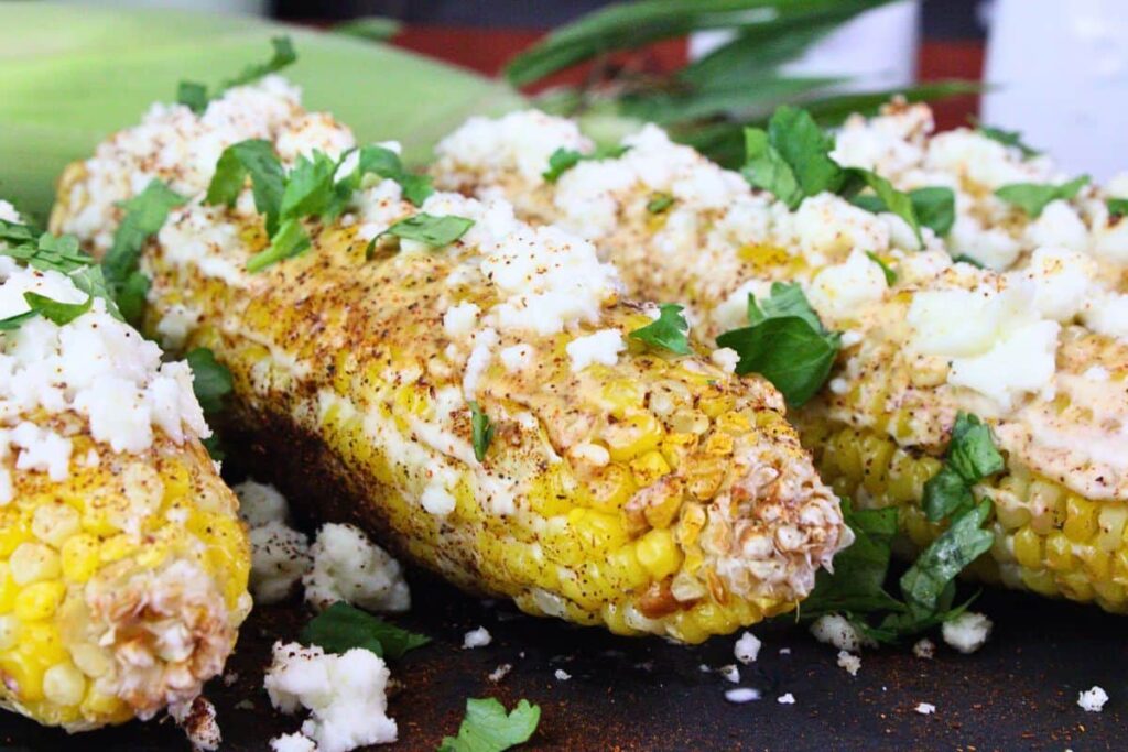 closeup view of air fryer mexican street corn showing off cojita cheese and cilantro