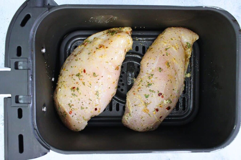 place lemon garlic chicken breasts in air fryer basket