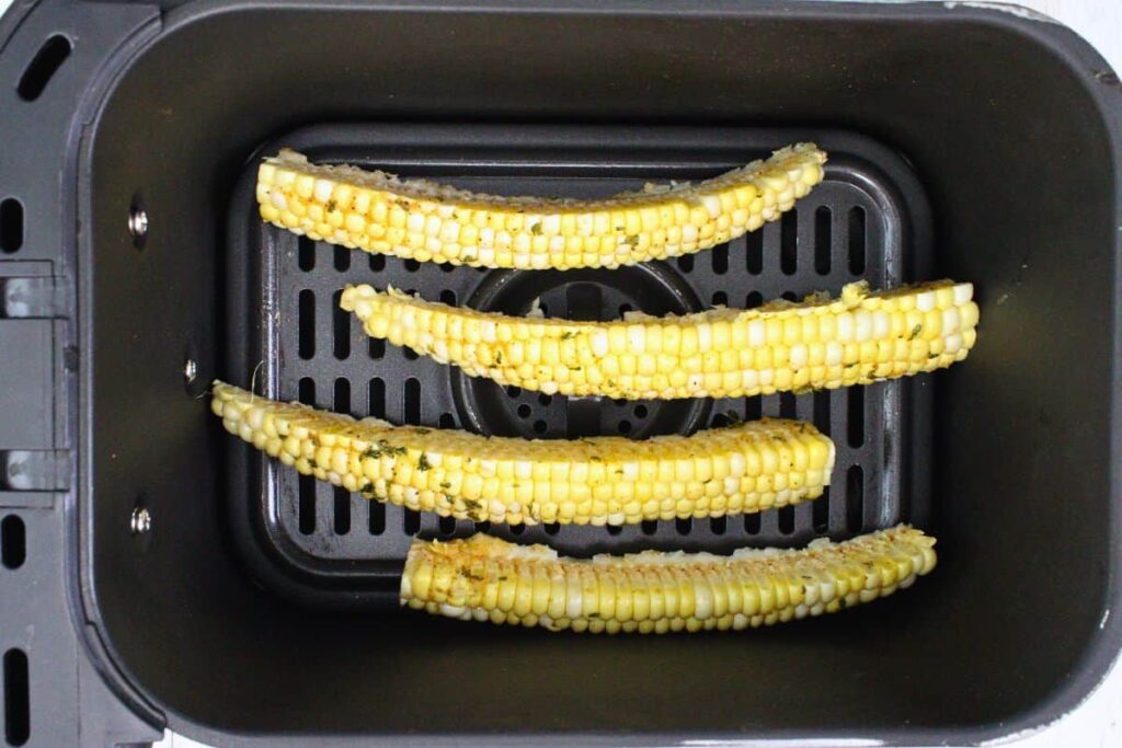 place seasoned corn ribs in air fryer basket