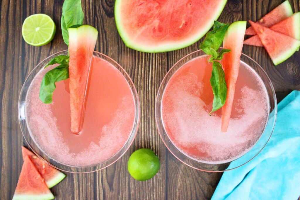 overhead view of two watermelon martinis garnished with watermelon and basil