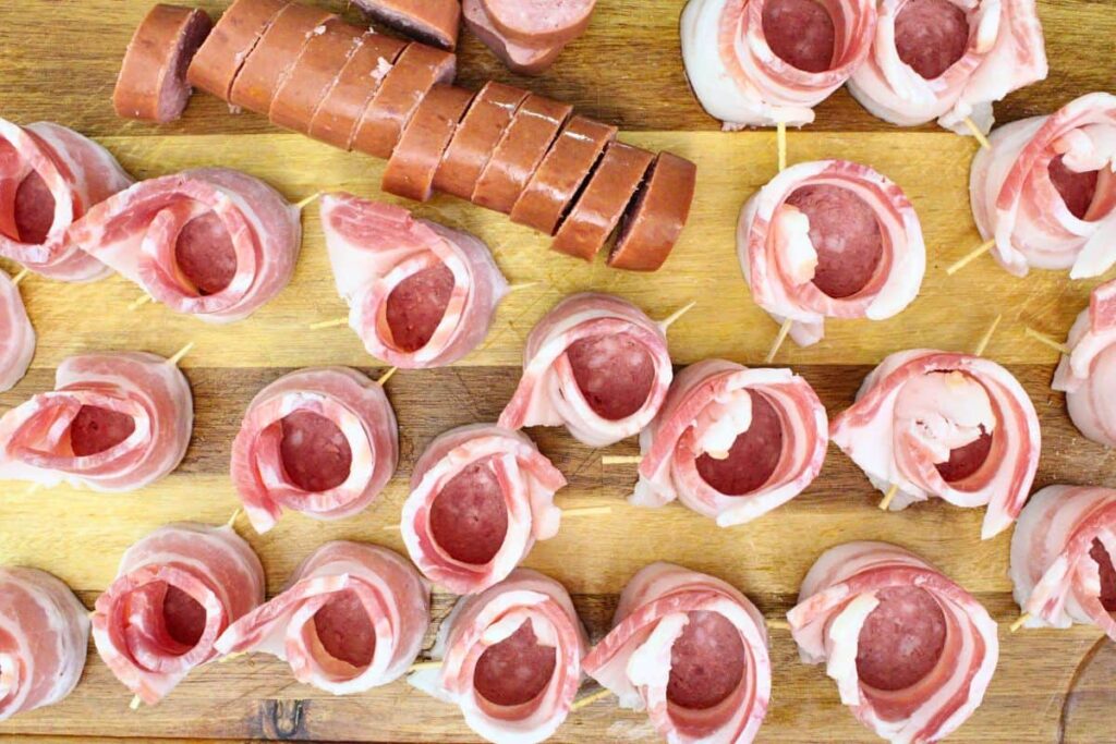 slice kielbasa and wrap half a slice of bacon around each piece