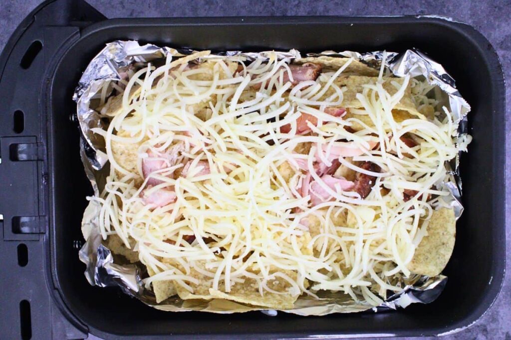 add a second layer of nacho chips, cheese, and turkey to air fryer