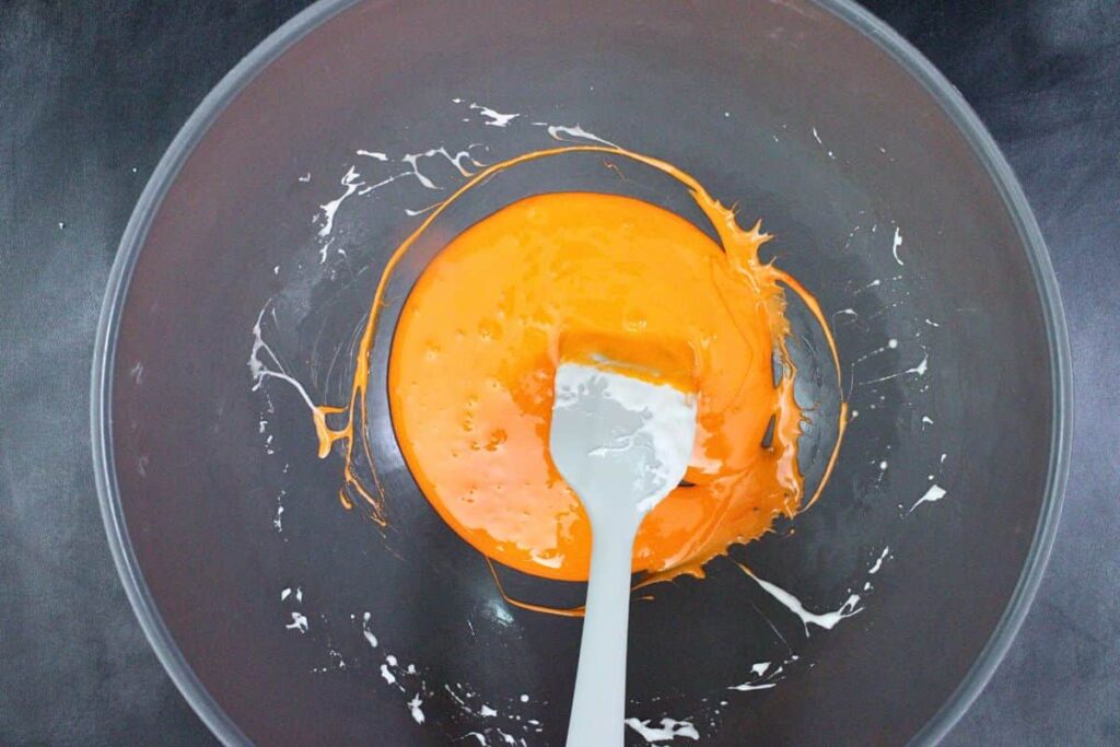 add orange food coloring to marshmallow krispie treat mixture