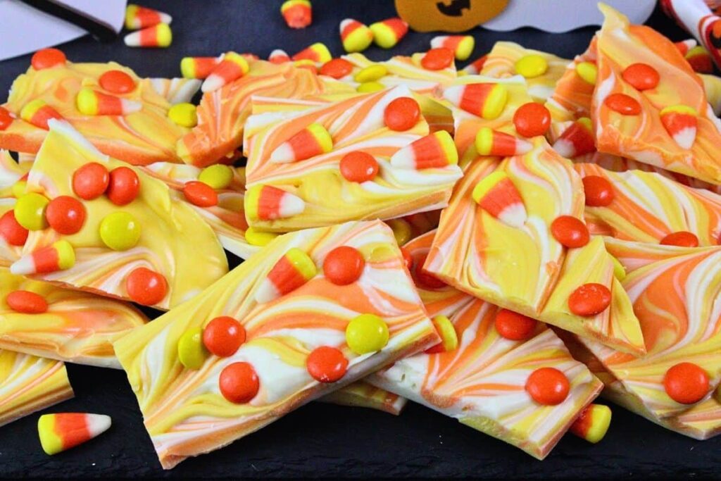 looking down at a pile of candy corn bark with colored swirls and candy pieces