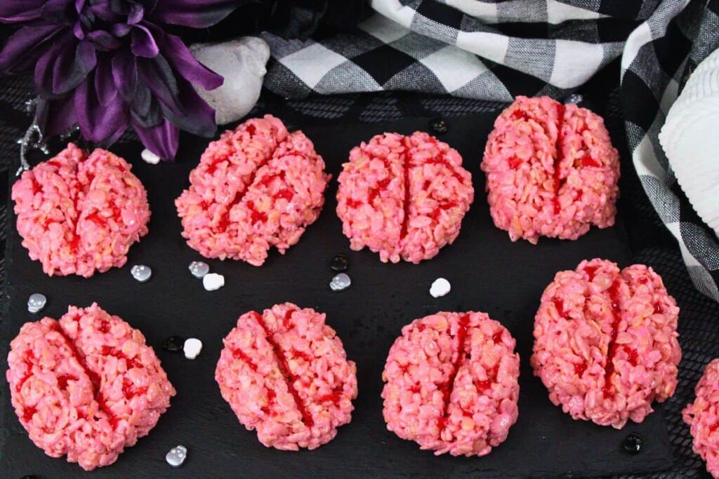 overhead view of several brain rice krispie treats on black slate