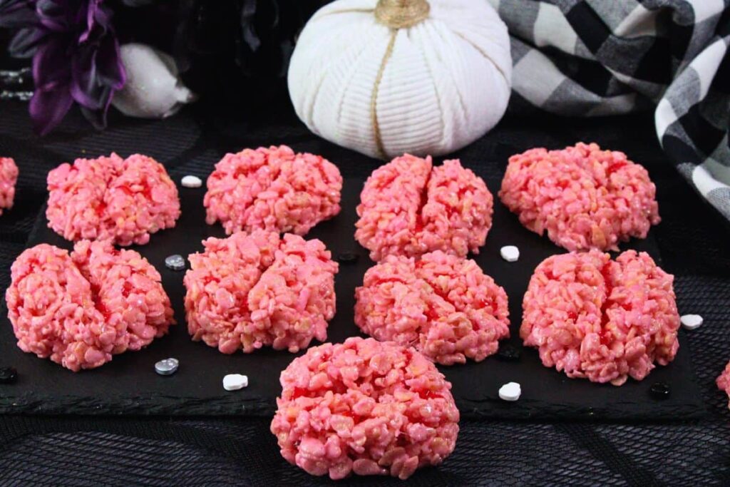 several brain rice krispie treats on slate with white pumpkin in the back