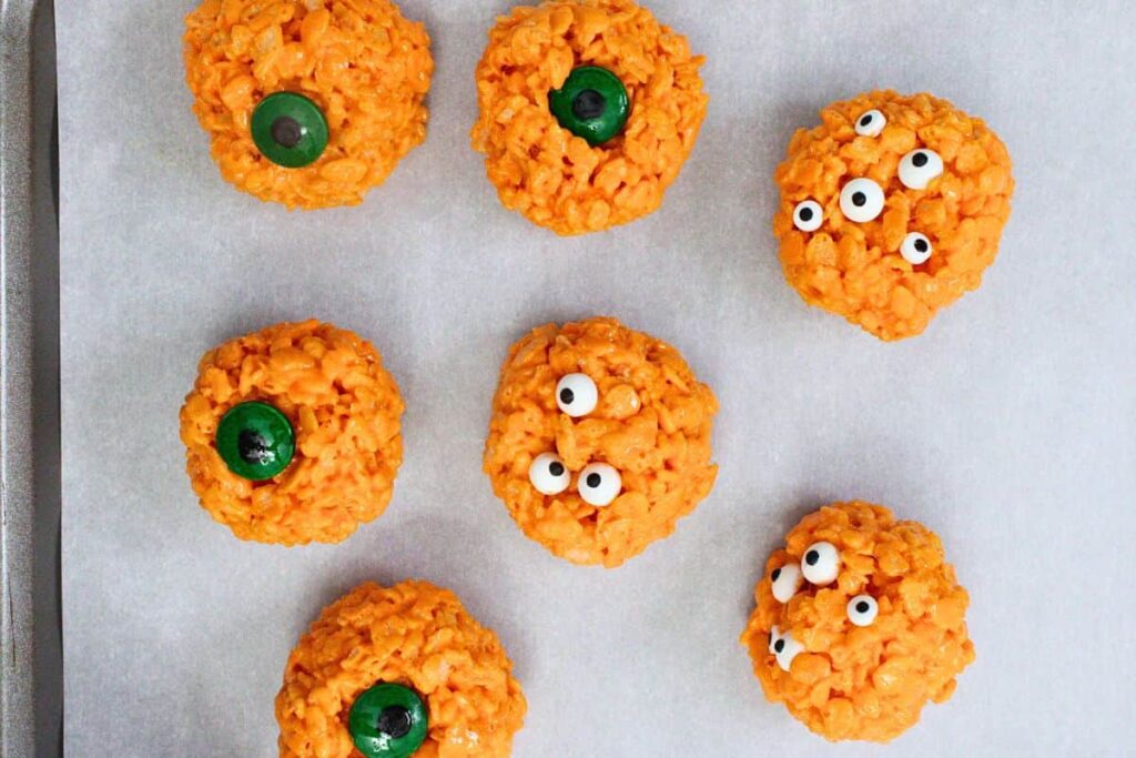 shape orange rice krispie treats into balls and press in candy eyes