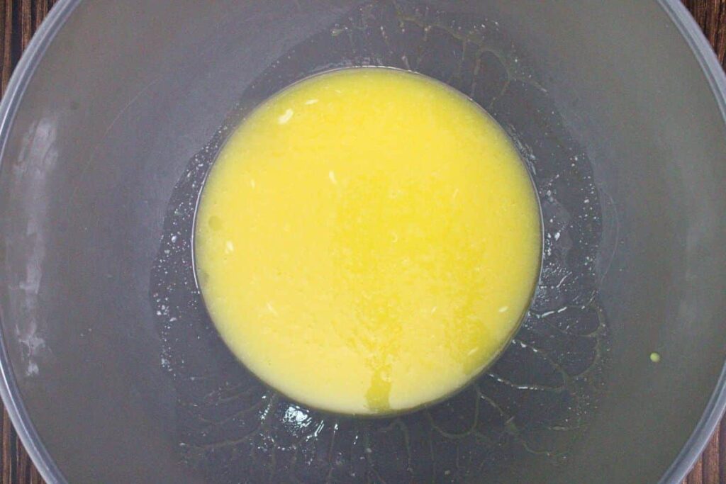 thoroughly whisk eggs with melted butter and sugar in a mixing bowl