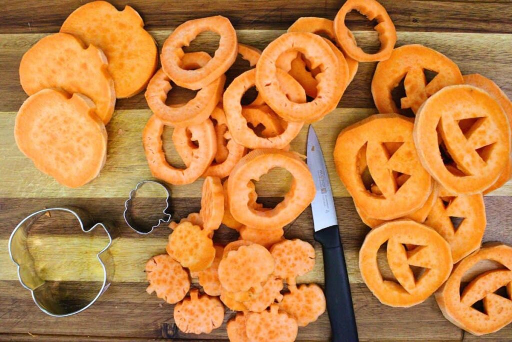 use cookie cutter or knife to cut jack o lantern faces or pumpkins out of potato slices