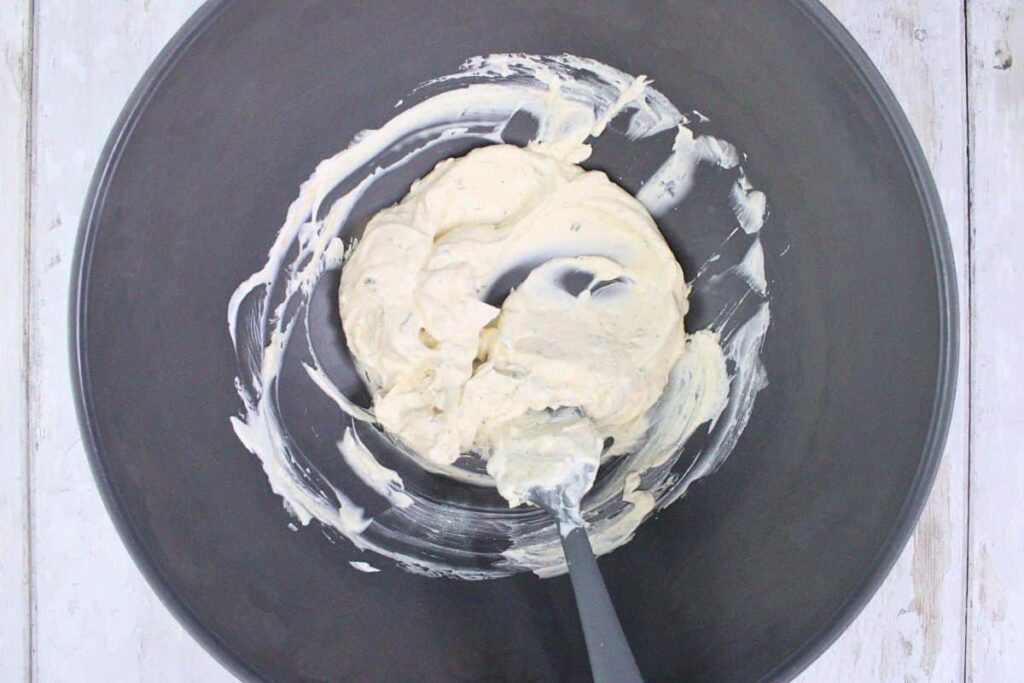 mix boursin, sour cream, hot sauce, and seasonings in a bowl