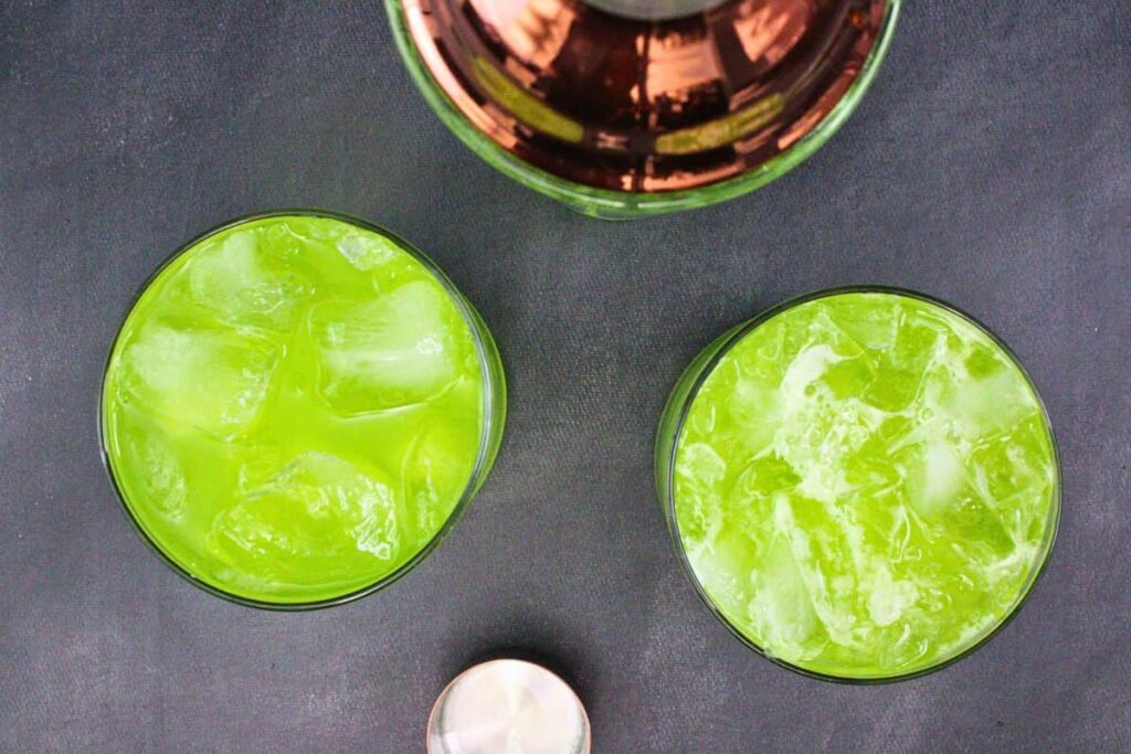 shake and strain chilled alien secretion drink into glass with ice cubes