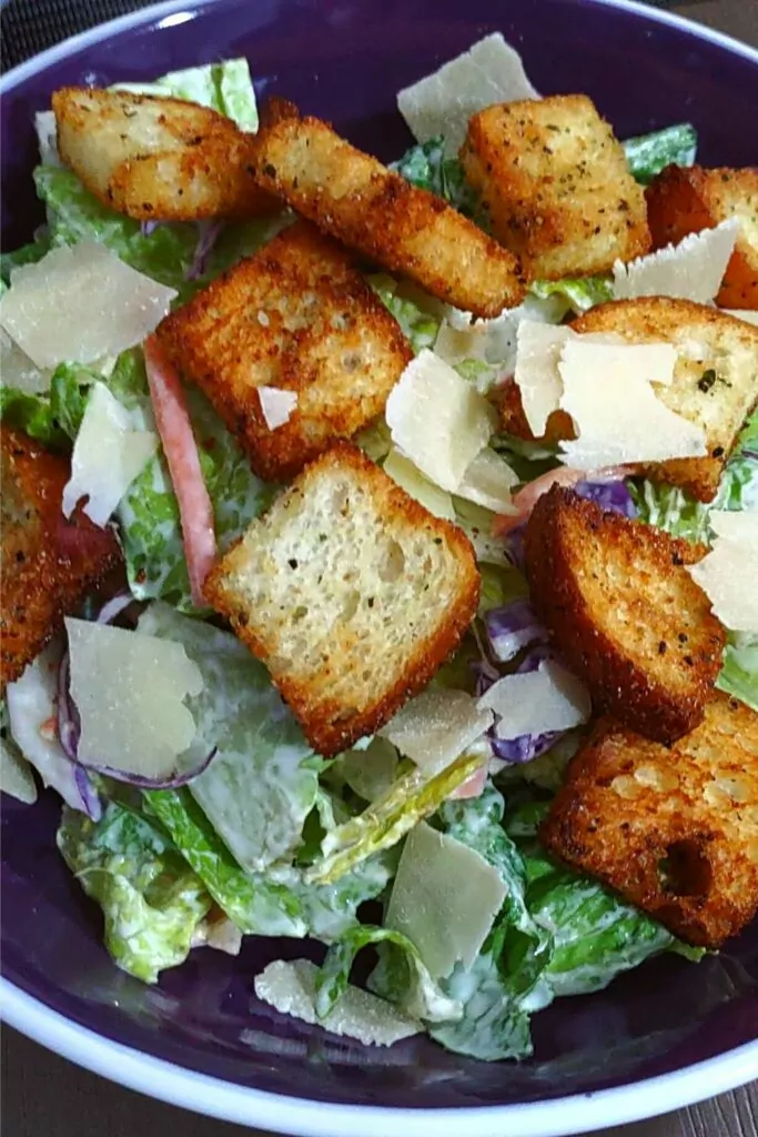 garlic and herb air fryer croutons on top of a salad