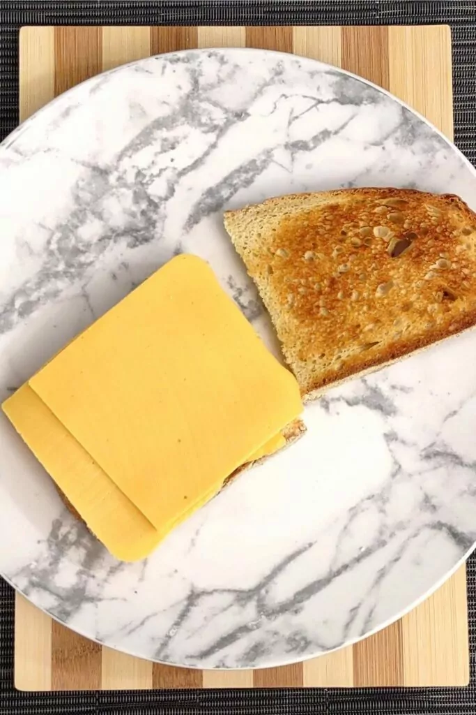 place two slices of cheese on your toasted bread
