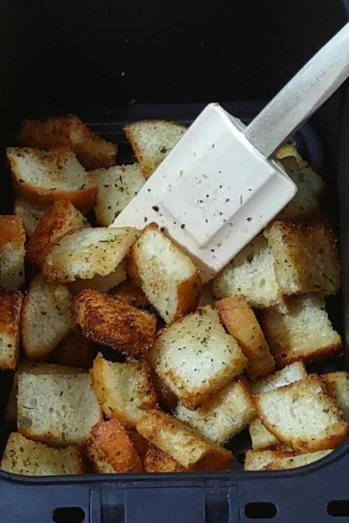 toss partially cooked croutons in air fryer basket