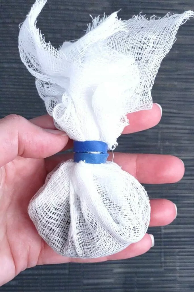 secure coffee grounds in cheese cloth by tying it into a bag