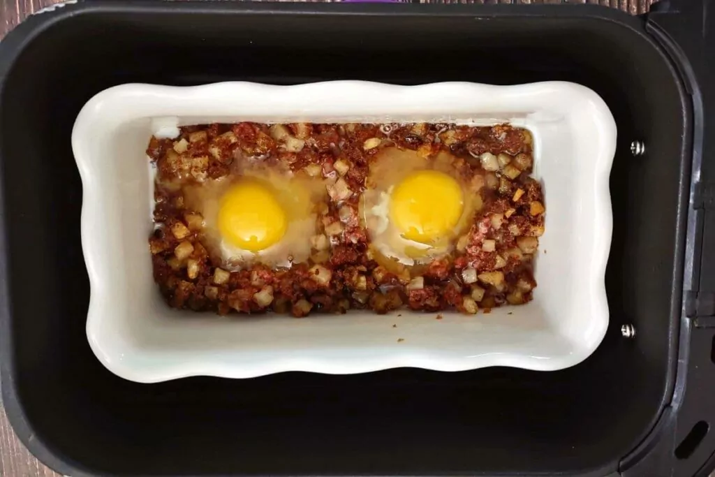 add eggs to the open spots in the corned beef hash