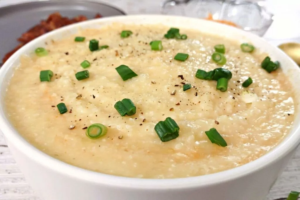 closeup of a bowl of microwave grits with garlic and cheese