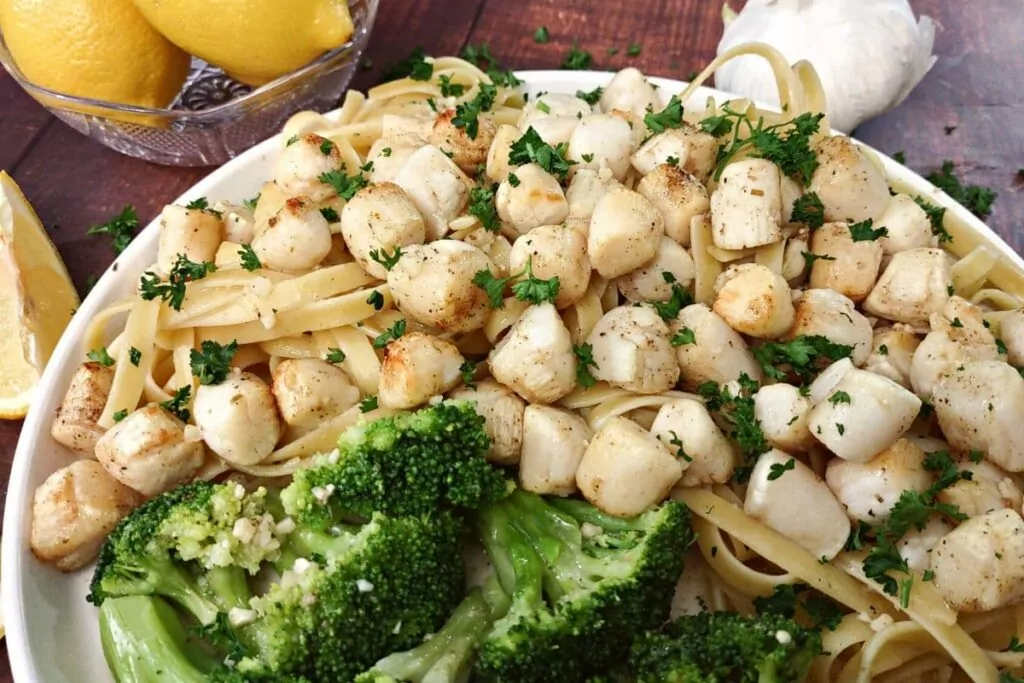 serve air fryer scallops over pasta with a side of vegetable