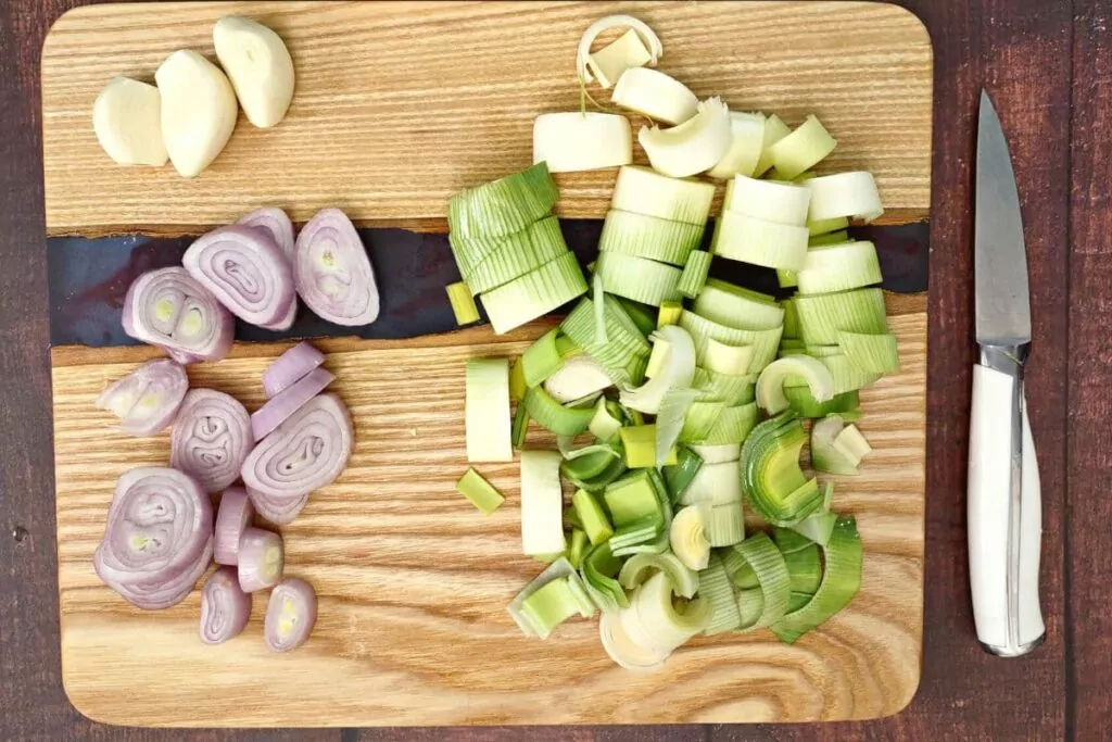 slice shallots, leeks, and garlic cloves