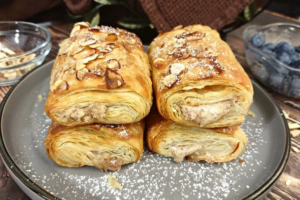 air fryer trader joe's almond croissants stacked on top of each other on a plate