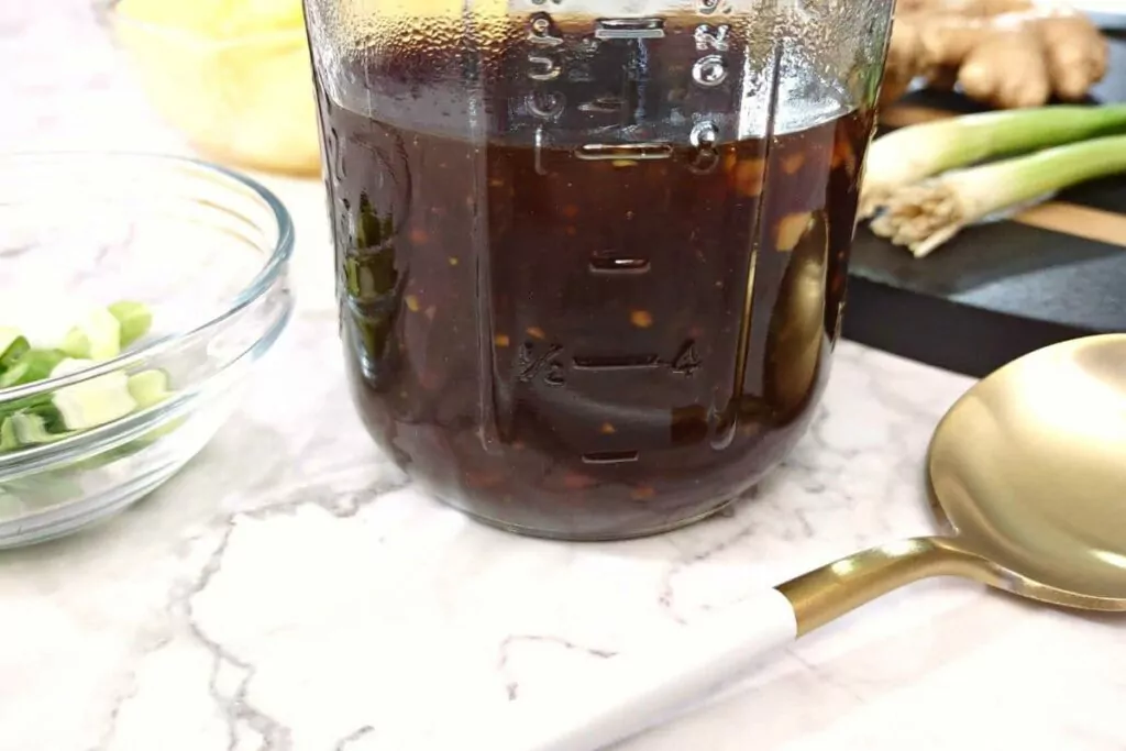 closeup of half a mason jar filled with homemade teriyaki sauce