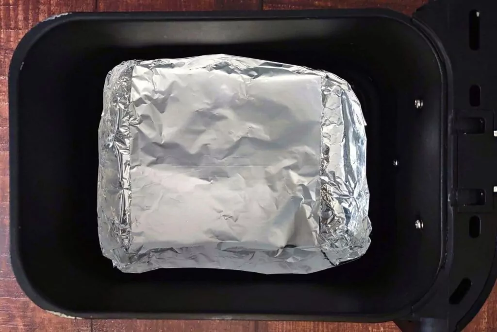 place foil tray in air fryer basket