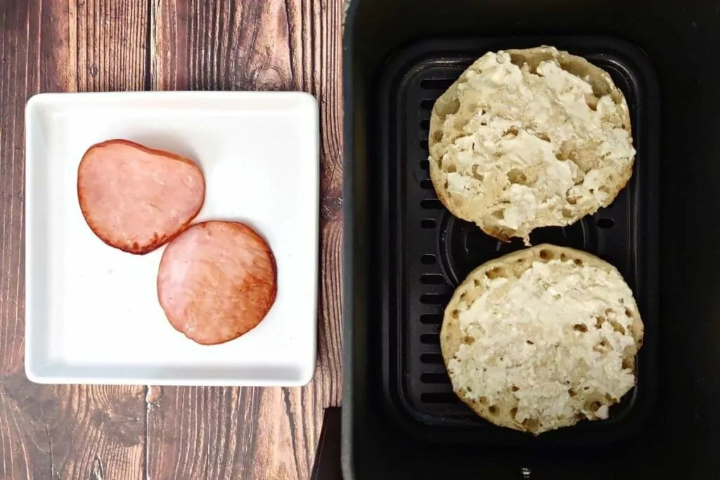 remove canadian bacon and add english muffins to air fryer basket