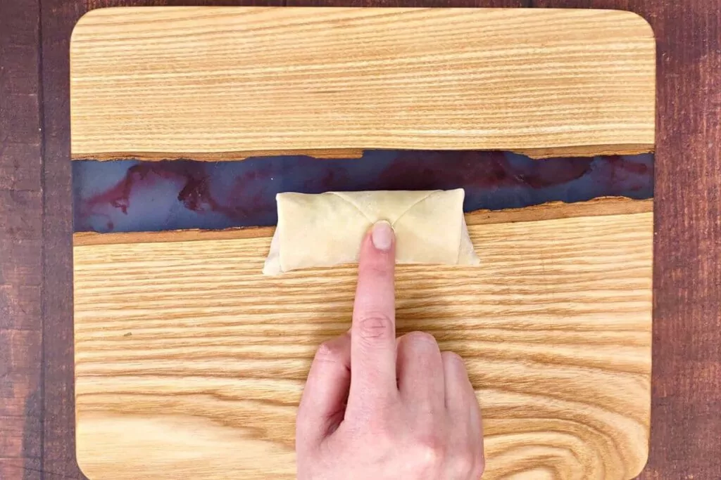 roll ingredients over to the top of the wrapper