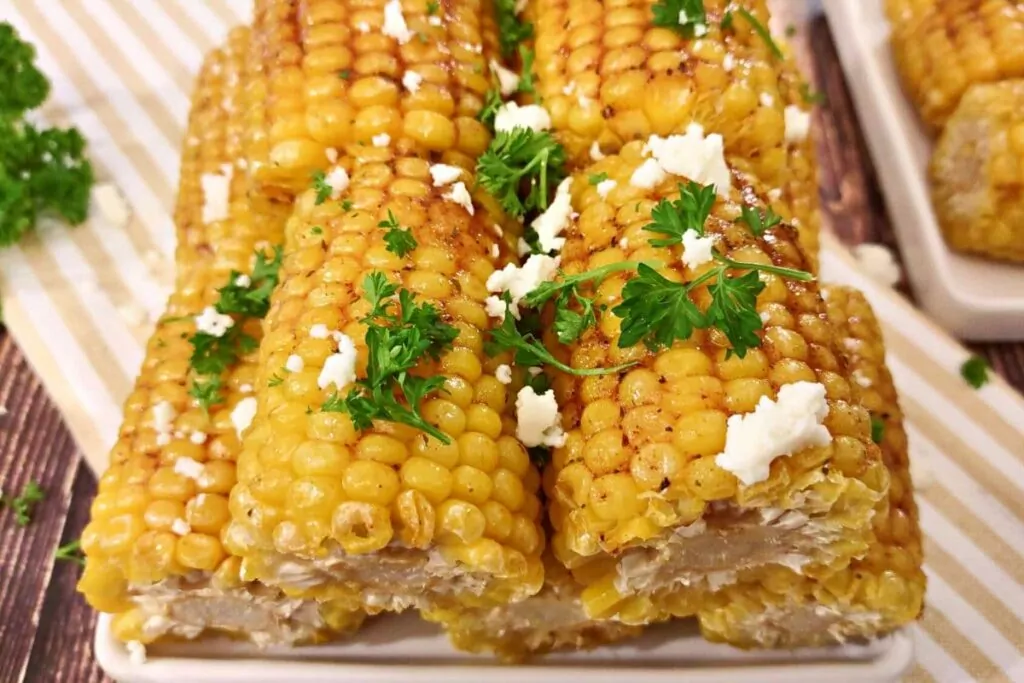 air fryer frozen corn on the cob with parsley and crumbled cheese
