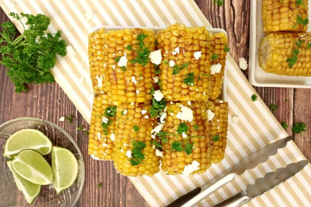 overhead view of air fryer corn on the cob stacked up on a plate