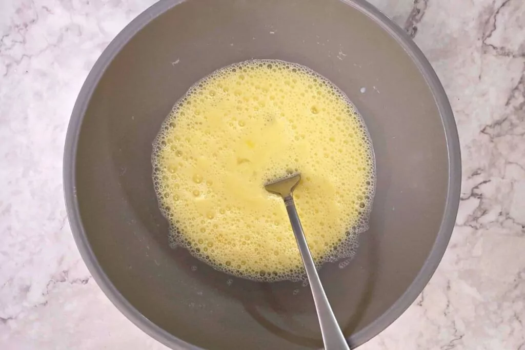 whisk eggs and milk in a bowl