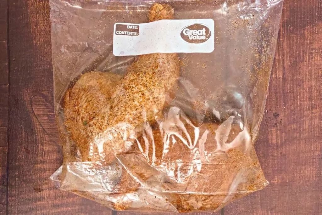 mix chicken quarters in bag with seasoning