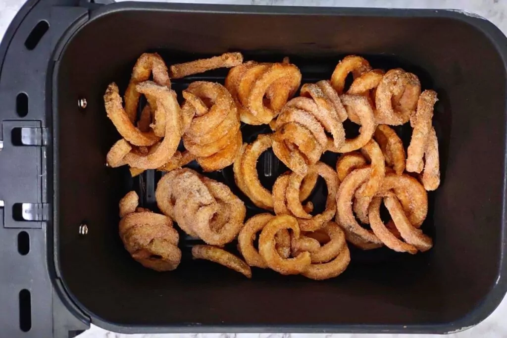 place frozen curly fries in air fryer basket