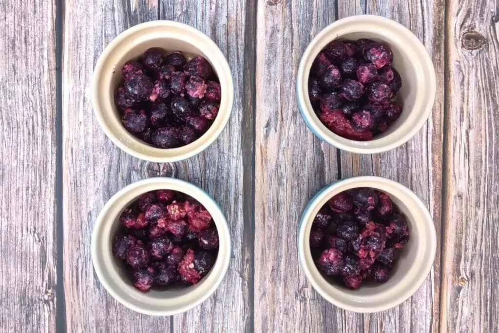 add your blueberries to the bottom of the ramekins