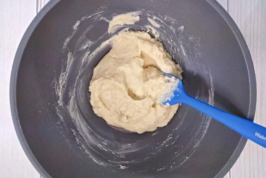 mix flour, sugar, baking powder, melted butter, and cream in another bowl