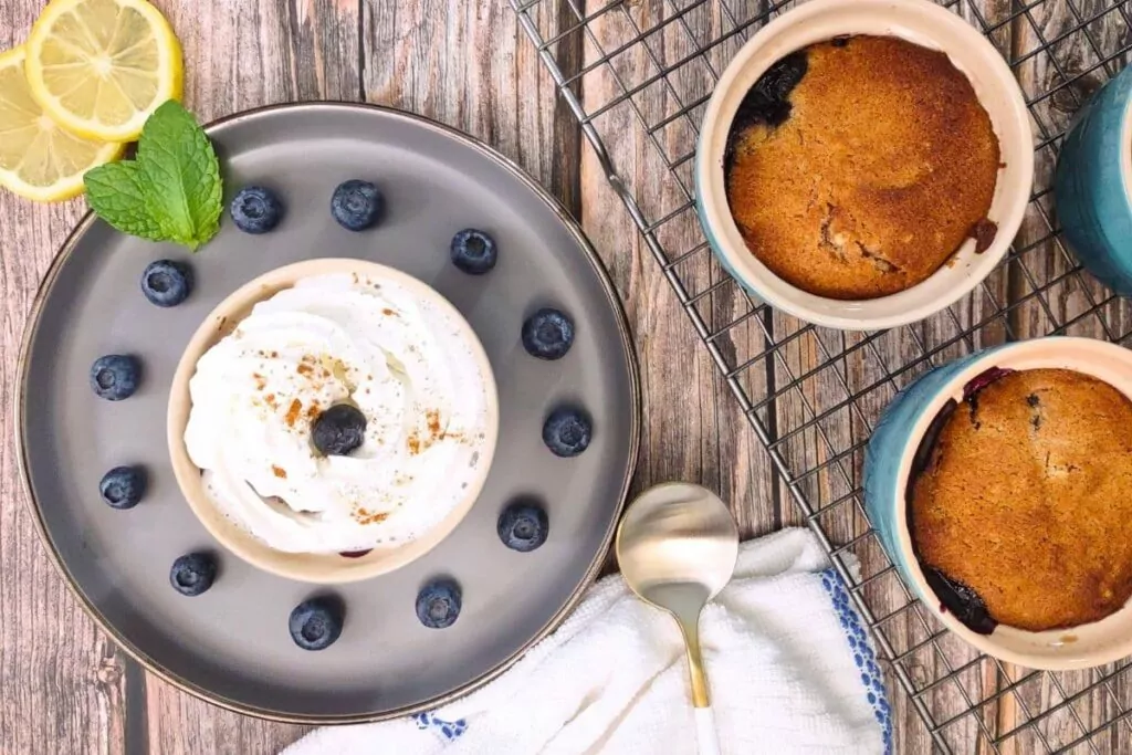 overhead view of air fryer blueberry cobbler on a plate with whipped cream