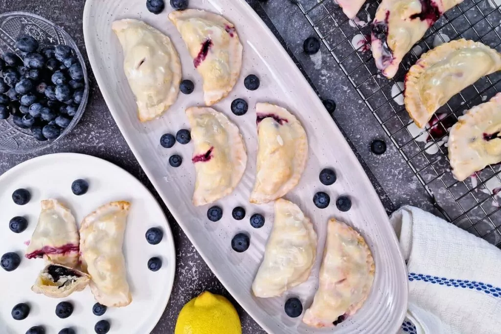 overhead view of air fryer blueberry hand pies on a long platter