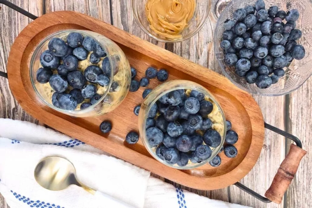 overhead view of peanut butter blueberry overnight oats in two glasses