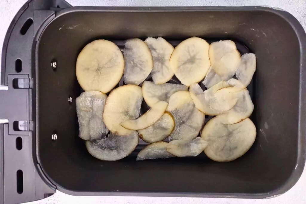 place sliced potatoes in air fryer basket