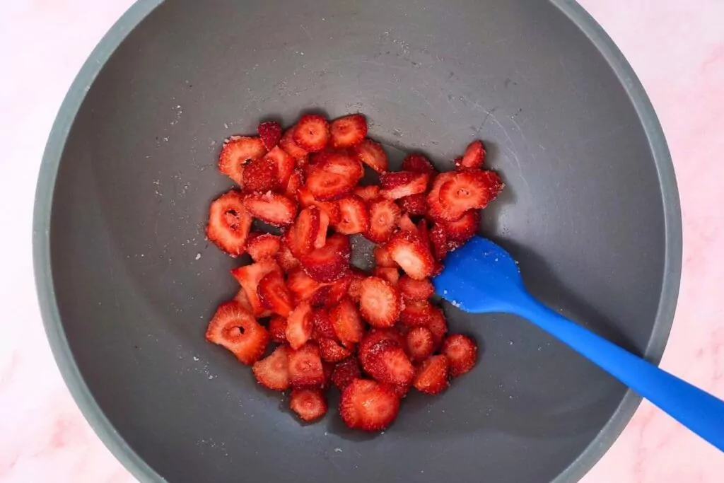 combine strawberries and sugar in a bowl