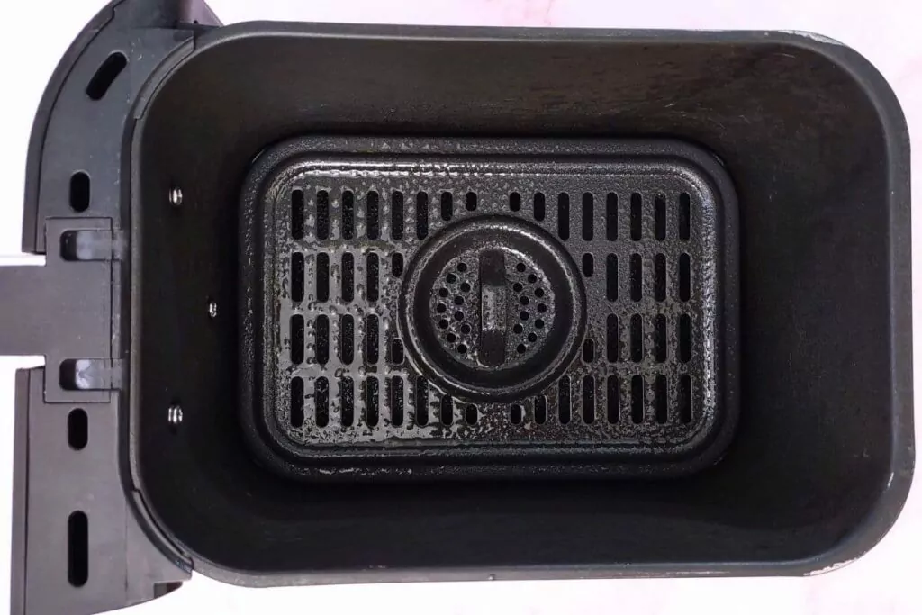 grease the bottom of your air fryer basket before adding biscuits